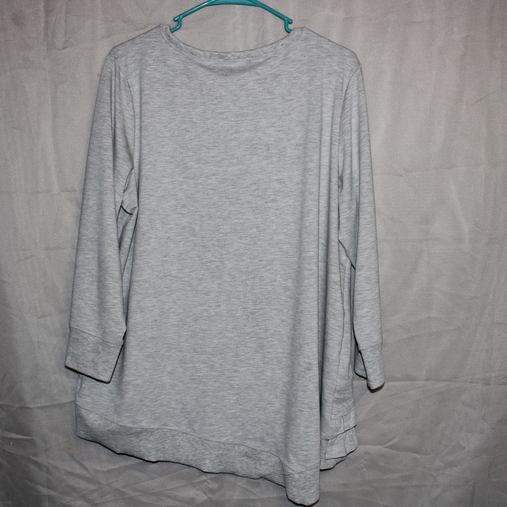 A Grey Long Sleeve with ruffles on the bottom